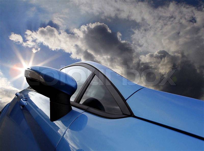 Exterior mirror of a car with cloudy sky, stock photo