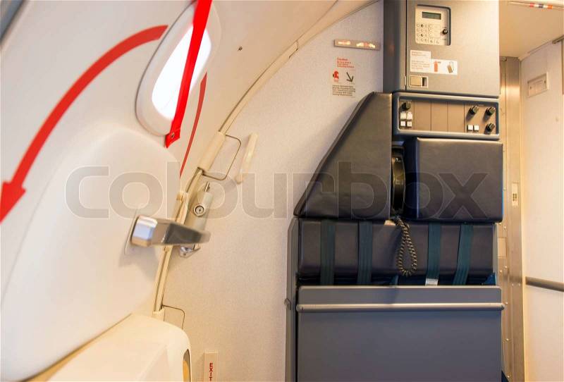 Airplane door and attendant seating place, stock photo