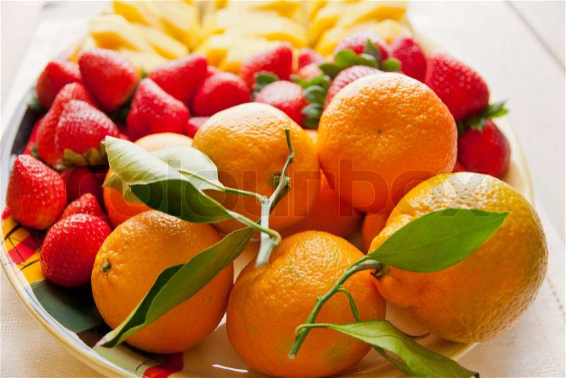 Mixed fruit platter with strawberries, pineapple and mandarins. selective focus, stock photo