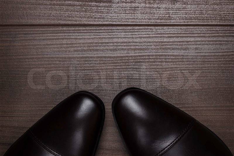 Shy man standing on the wooden floor background, stock photo