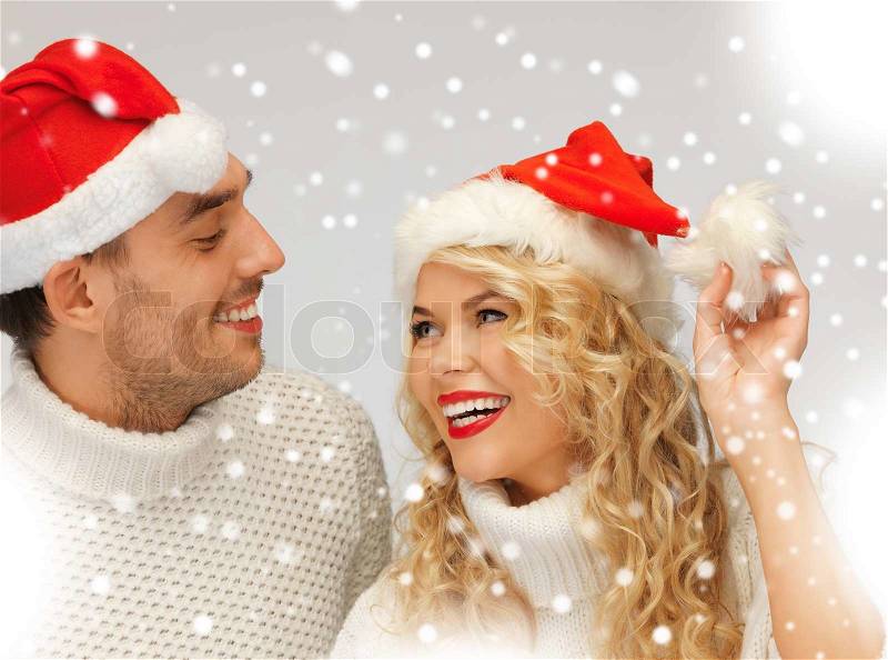 Family couple in sweaters and santa\'s hats, stock photo