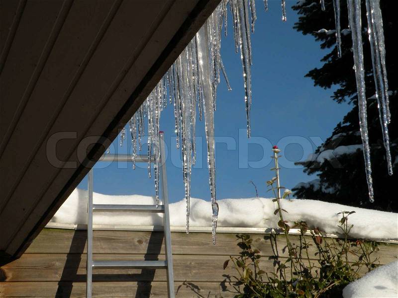 Close up of ice taps hanging down the roof, stock photo