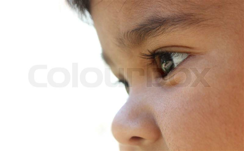 Extreme closeup of indian baby girl\'s face who looks like day dreaming or imagining or curiously looking at something, stock photo
