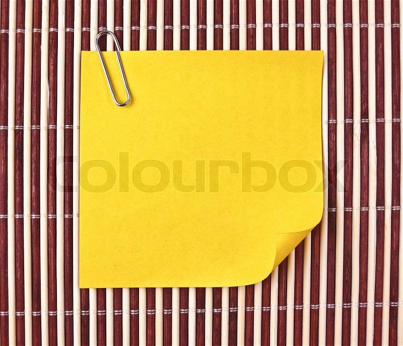 Yellow note on mat, stock photo