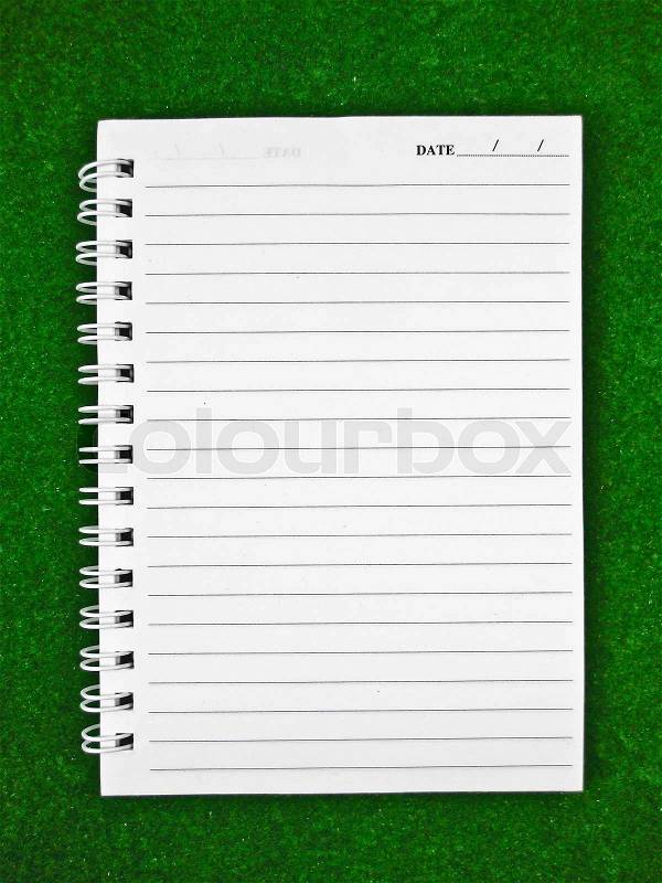 Notebook Paper on green background, stock photo