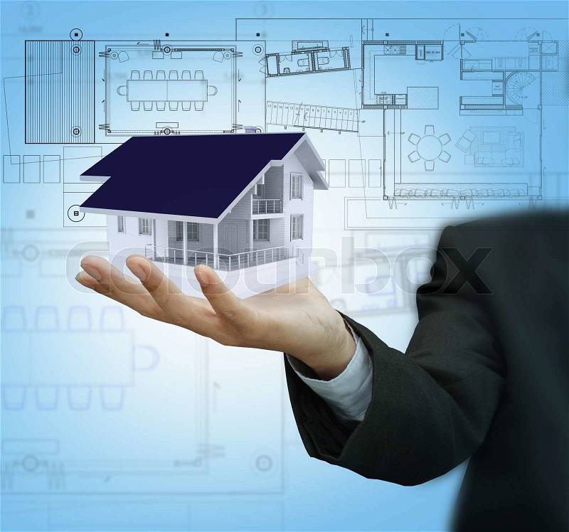 Businessman present house model and plan on touch screen, stock photo