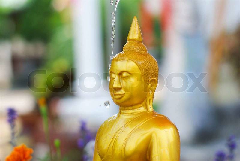 Water pouring to Buddha statue in Songkran festival tradition of thailand, stock photo