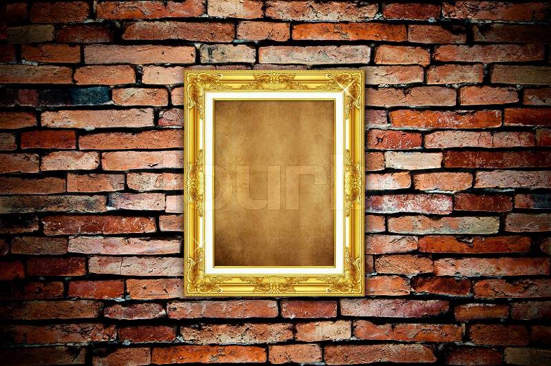 Golden frame on old brick wall, stock photo
