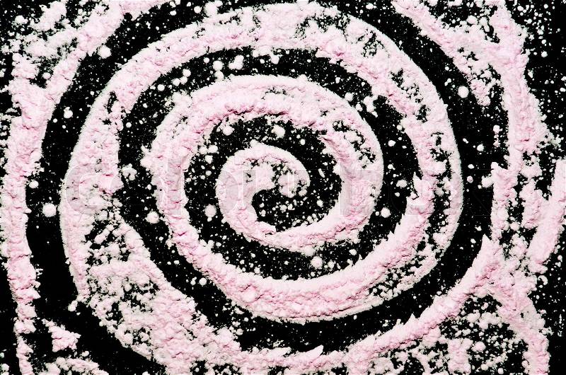 Spiral pink powder on black background, look like a galaxy, stock photo