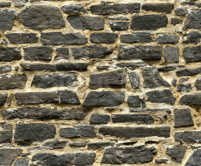 Seamless black ashlar old stone wall texture, stock photo