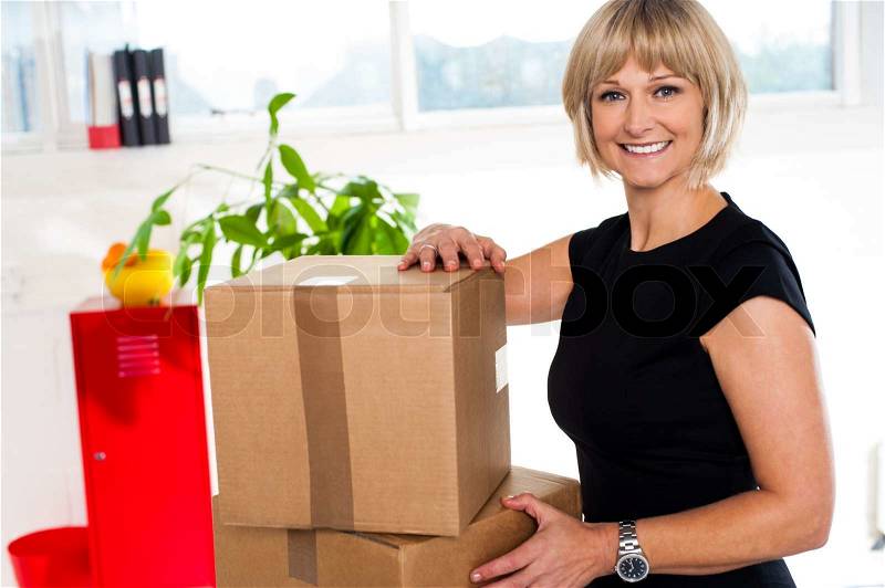 Blonde woman is ready to unpack her office stuff, stock photo