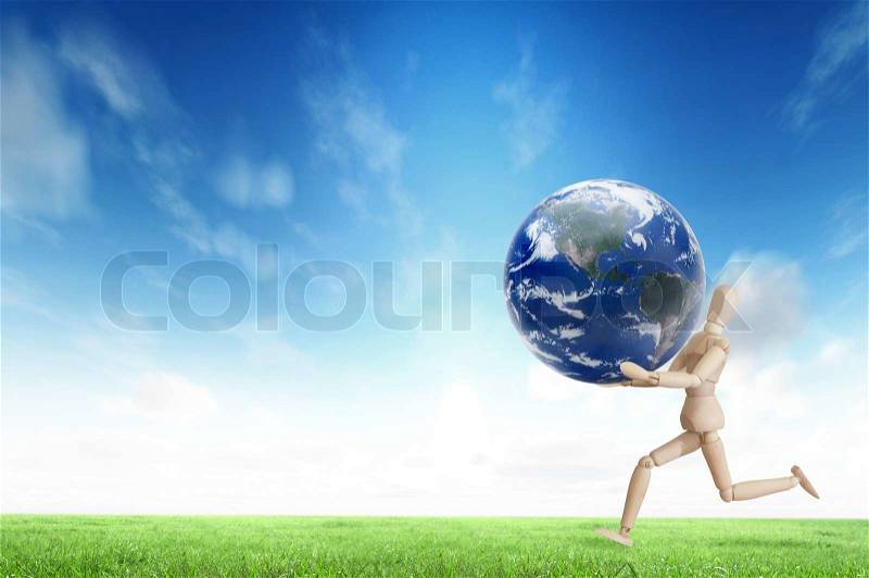 Wooden model running with planet on the hand for eco and environmental concept, stock photo
