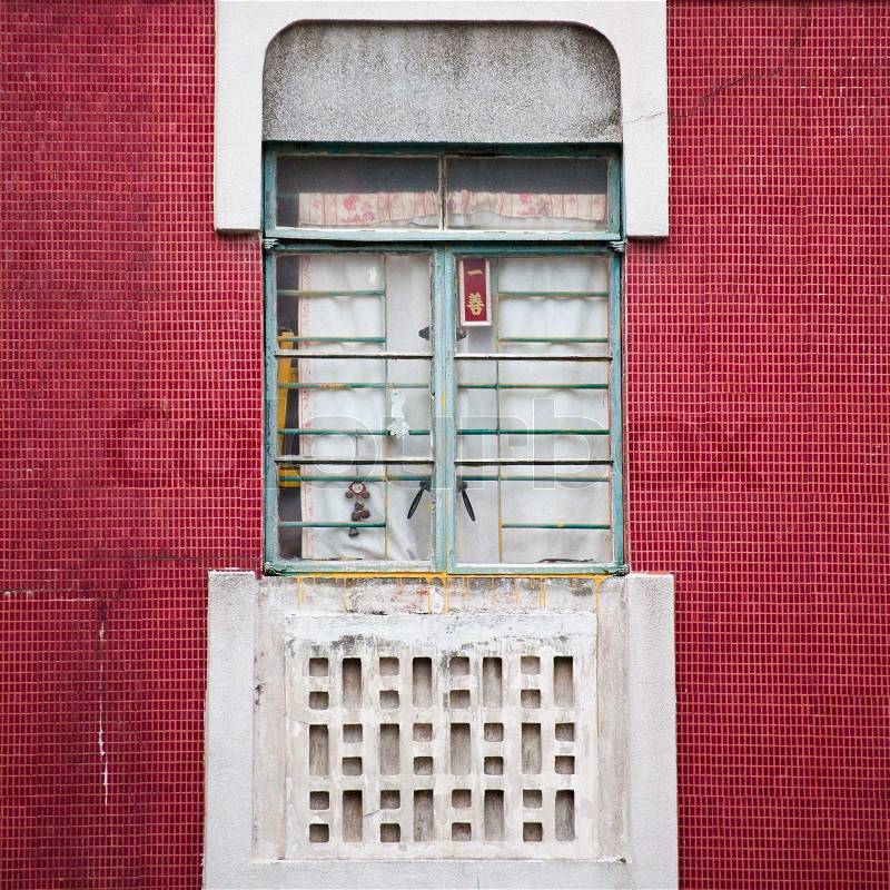 Chinese window on red tile wall, stock photo