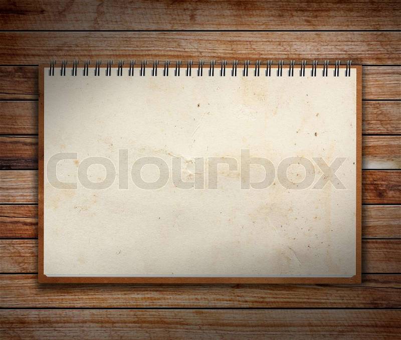Notebook paper on Old Wooden textures, stock photo