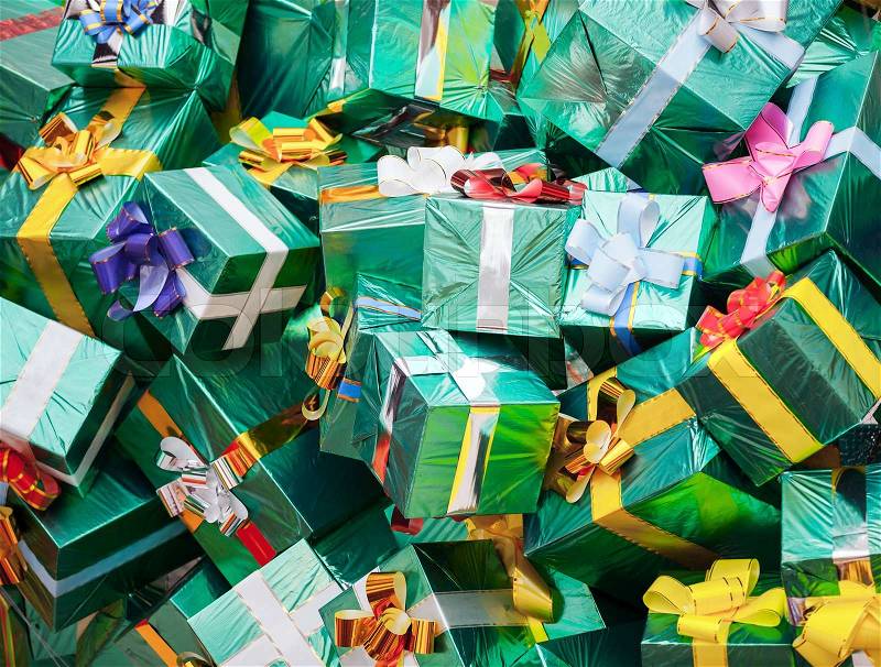 Huge pile of green gift boxes with colorful bows, stock photo