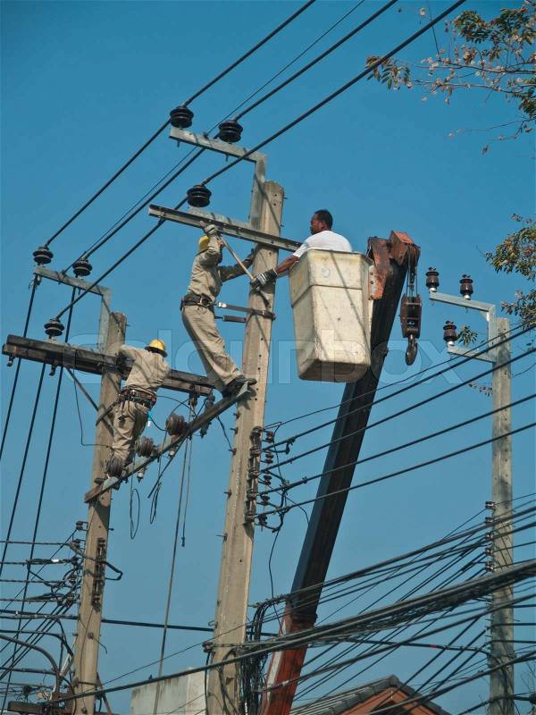 Electrician working on power line, stock photo