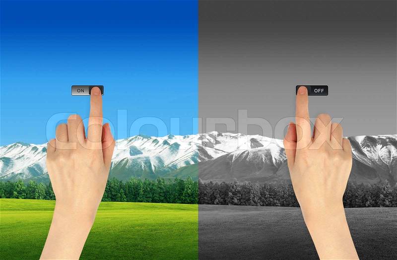 Hand press on and off button on landscape background for green eco concept, stock photo