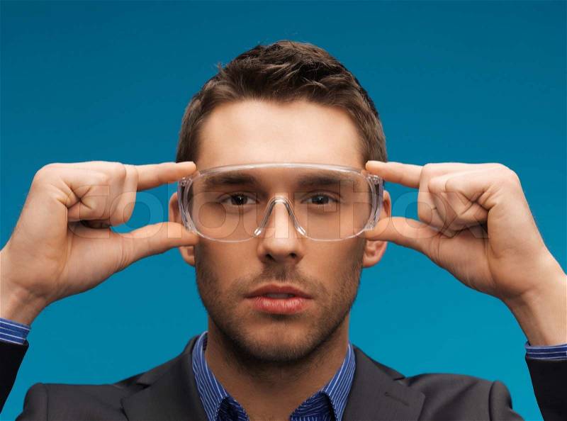 Businessman in protective glasses, stock photo