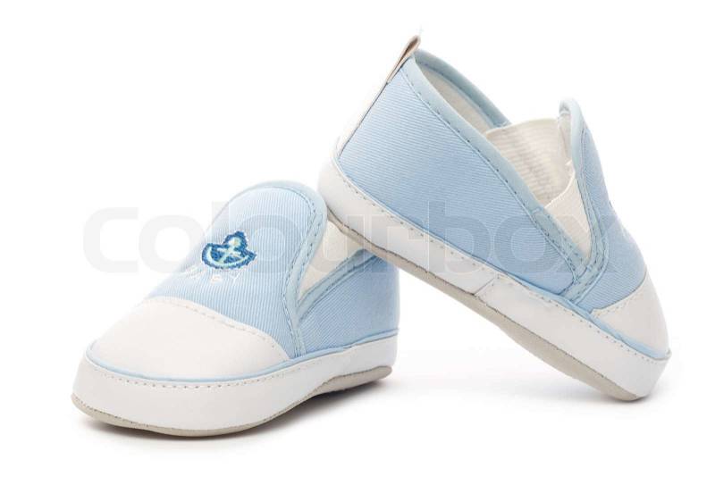 Little blue and white baby shoes with anchor logo isolated on white background, stock photo