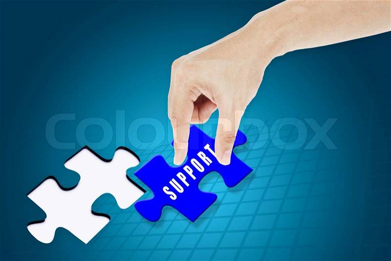 Hand inserting missing vision jigsaw puzzle, stock photo