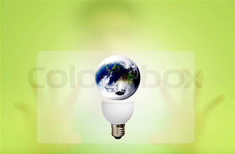 Man behind the green screen with bulb for green eco concept, stock photo