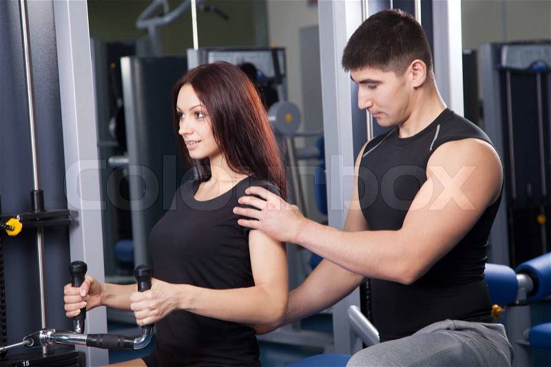 Trainer in a fitness center, stock photo