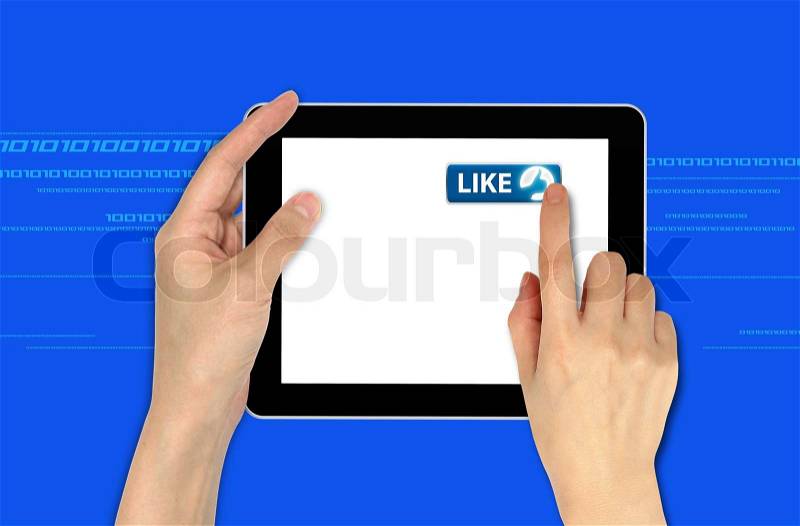 A male hand holding a touchscreen computer and pressing like button, stock photo