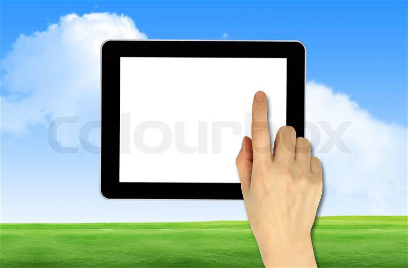 A male hand holding a touchpad on back ground blue sky, stock photo