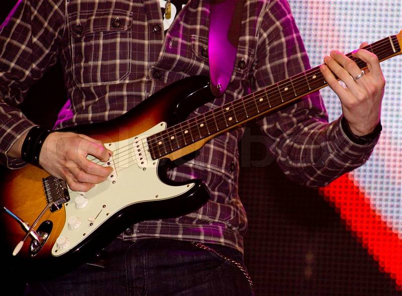 Close up of an electric guitar being played, stock photo