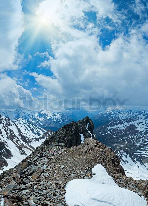 Mountain view with alp flowersover precipice and clouds, stock photo