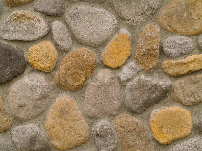 Rock and Concrete Wall with Large Rounded Stones, stock photo