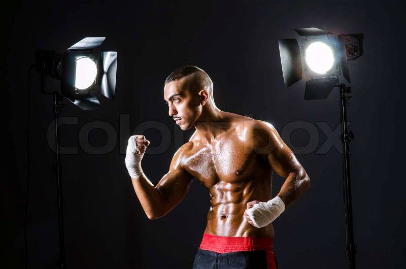 Boxer with studio lights in sports concept, stock photo