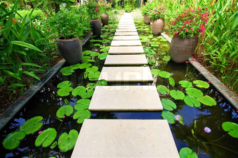 The Stone block walk path in the garden on water, stock photo