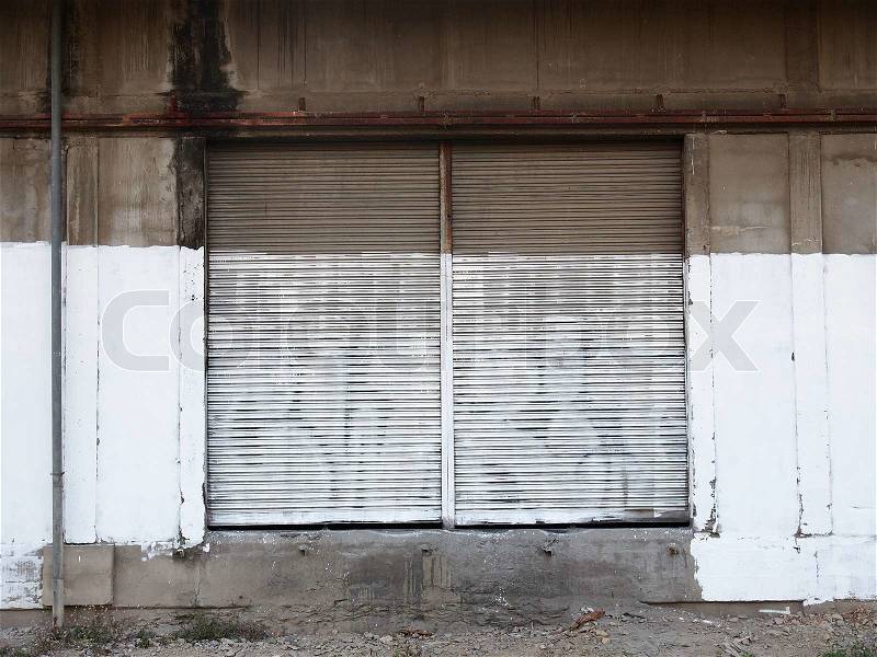 Shutter door and unfinish painted wall, stock photo