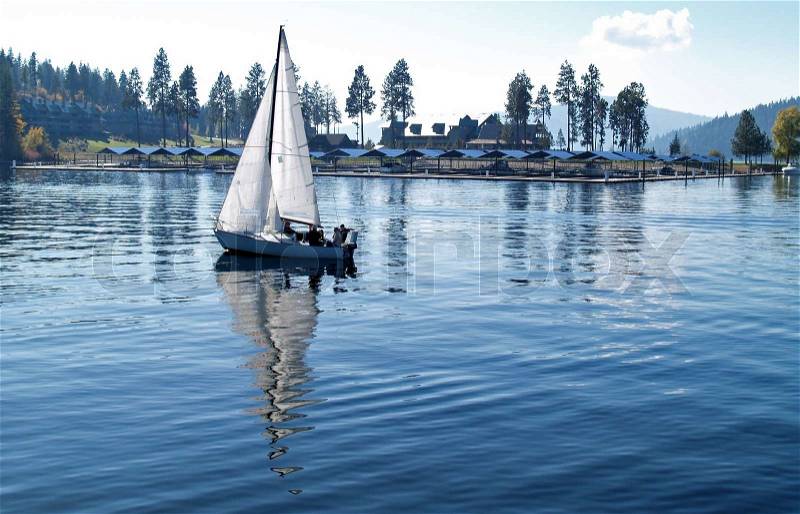 Sailboat Sailing on a Blue Mountain Lake, stock photo