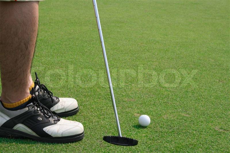 Golf putting by a man, stock photo