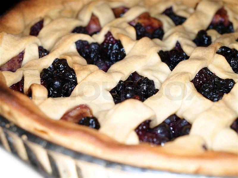 Fresh dark blue berry pie, covered with shortcrust pastry, stock photo
