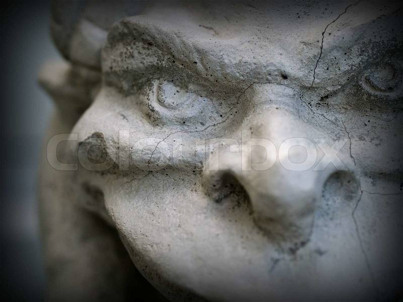 Gargoyle Statue Emphasis on Face and Eyes with a Dark Border, stock photo