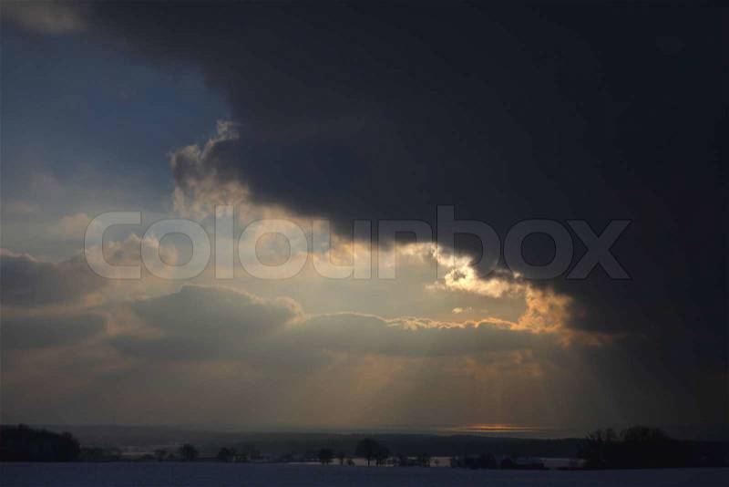 Dark clouds gives way for the sun, stock photo