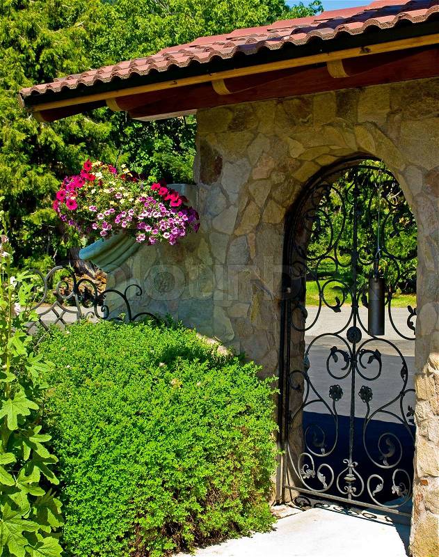 Wrought Iron Garden Gate in a Fancy Garden, stock photo