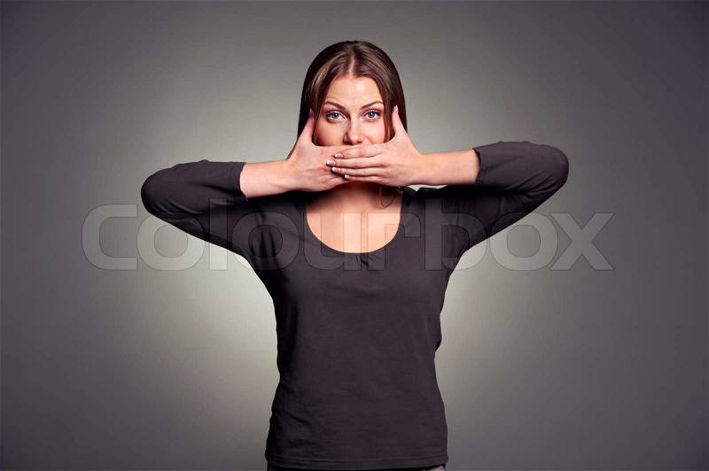 Woman holding hands over her mouth, stock photo