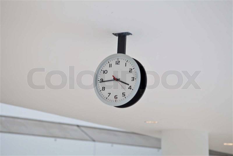 Ceiling Clock in a building corridor, stock photo