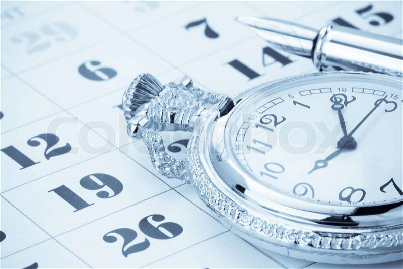 Ink pen and watch on calendar, stock photo