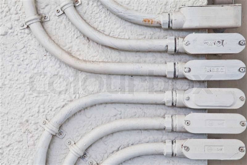 Integration of electricity pipe on house wall, stock photo