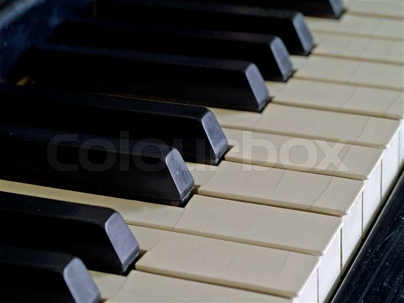 Piano keys of a very well loved and often played piano, stock photo