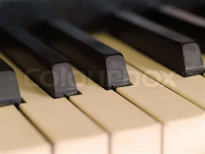 Piano keys of a very well loved and often played piano in Sepia, stock photo