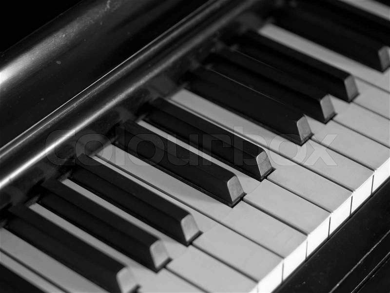Piano keys of a very well loved and often played piano in monochrome Black and Whit, stock photo