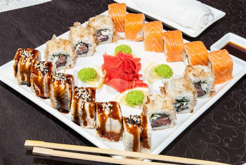Japanese rolls in a restaurant with fish and vegetables, stock photo
