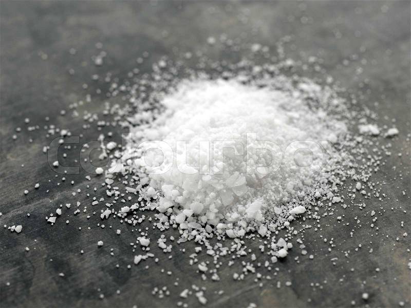 A pile of salt on the kitchen table, stock photo