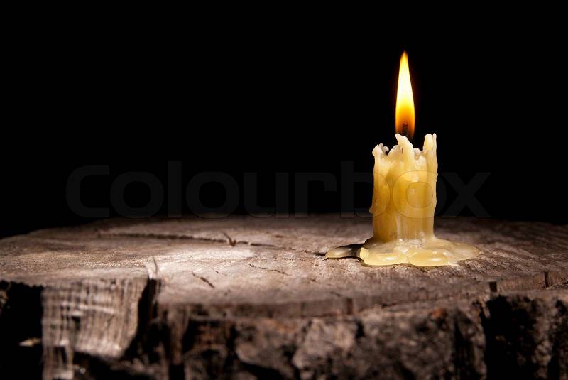 Old candle on the black background, stock photo